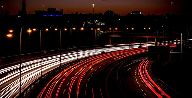 Nighttime highway with light trails
