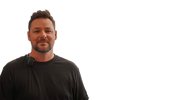 Smiling man in black t-shirt.